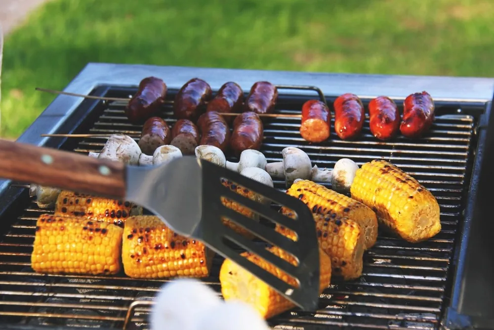 A barbecue grill with corn cooking
