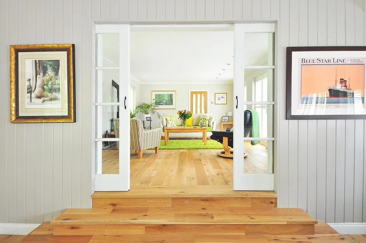 Open doors to a light-filled room with timber floors
