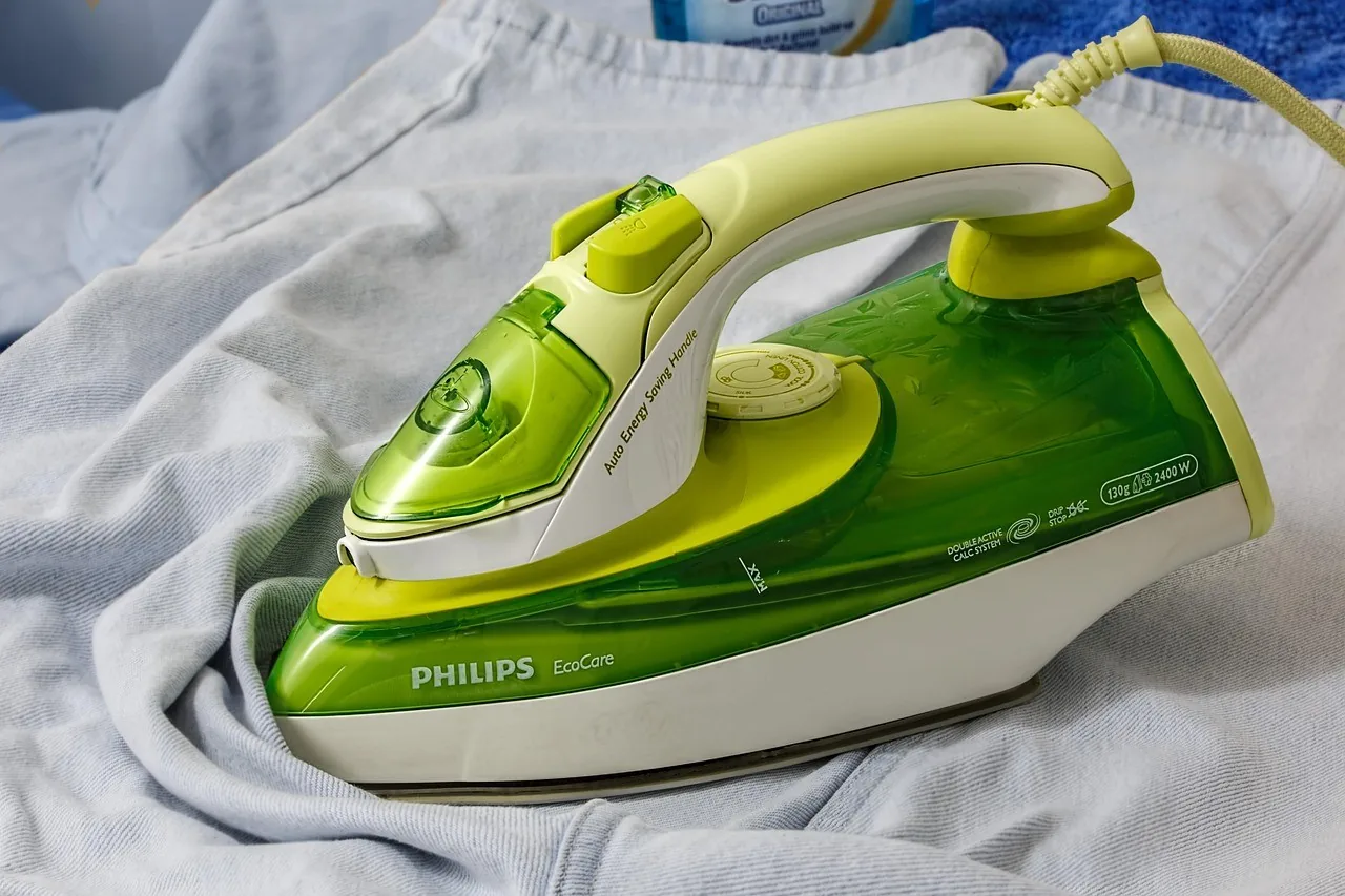An iron on a freshly ironed shirt