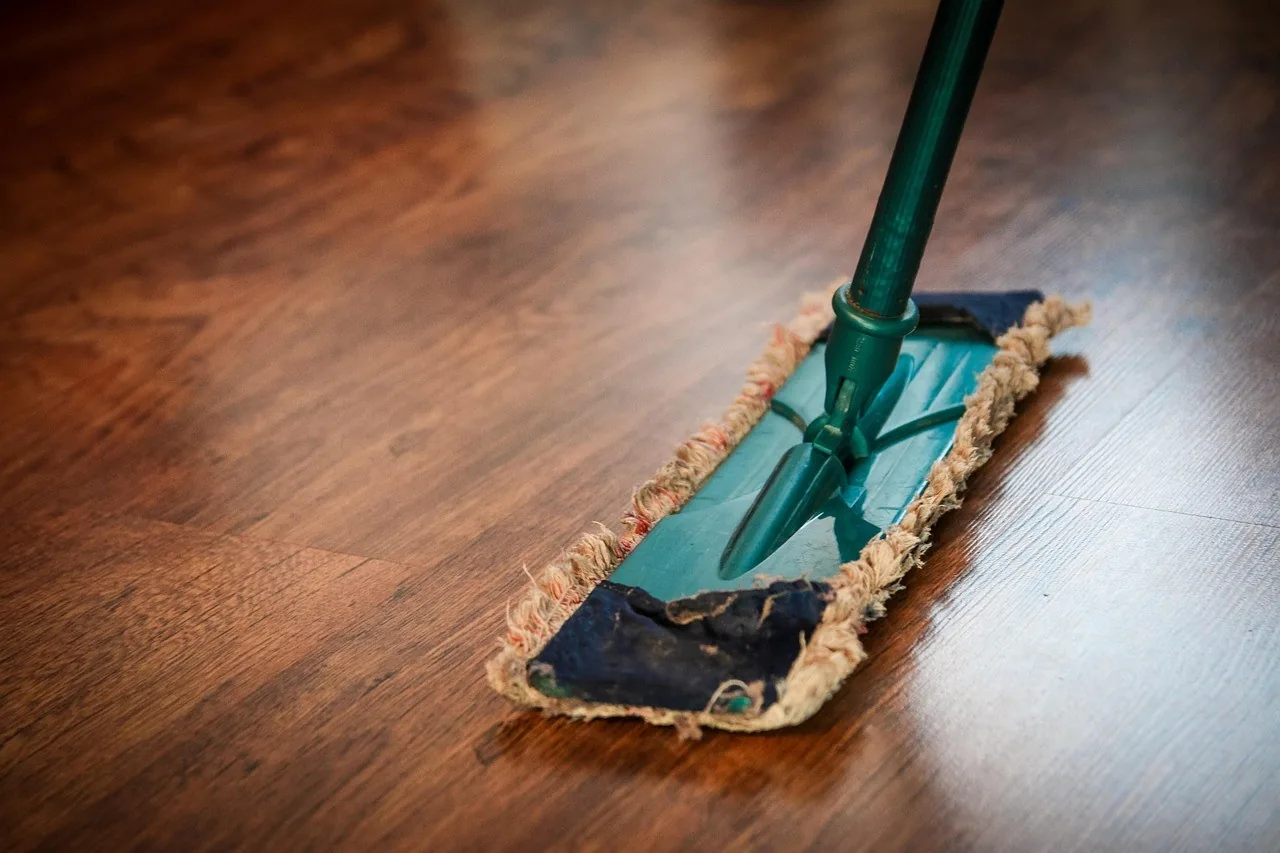A flat mop cleaning a timber floor