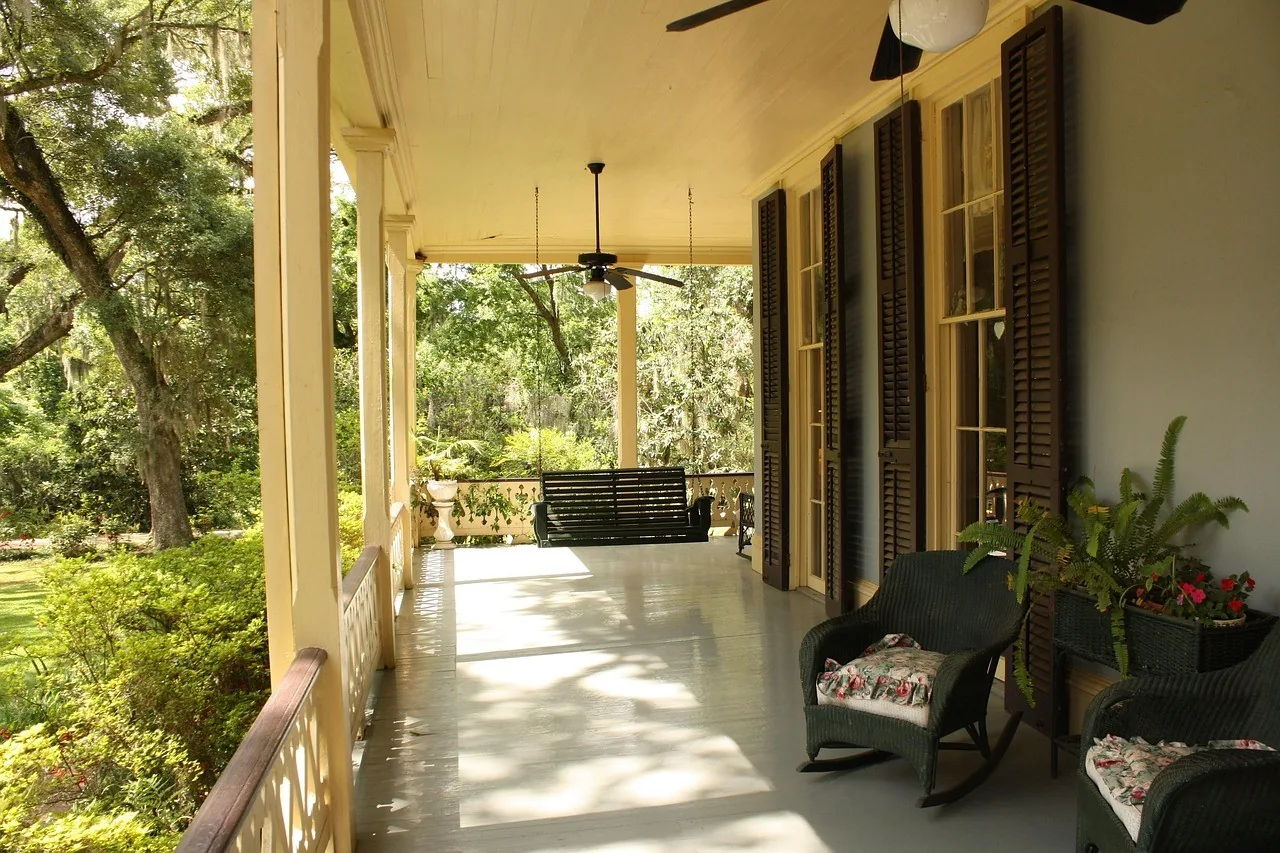 Two chairs on a shaded verandah looking out to the garden